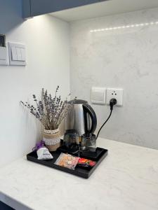 a kitchen counter with a coffee maker on a tray at Lavender House- The Sapphire Resident 2 in Ha Long