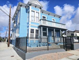 a blue house with a fence in front of it at Victorian Gem Close to Petco Park & Gaslamp in San Diego