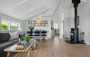 a living room with a couch and a wood stove at Stunning Home In Odder With Sauna in Odder