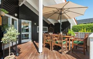 a patio with a table and an umbrella at Stunning Home In Odder With Sauna in Odder +12 photos