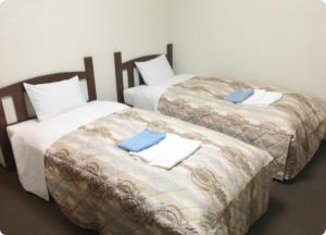 Giường trong phòng chung tại アーバンホテル森下