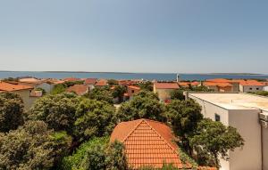 a view of a town with orange roofs and trees at 2 Bedroom Lovely Apartment In Mandre in Mandre