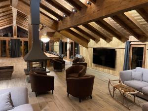 ein Wohnzimmer mit Kamin und einer Couch und Stühlen in der Unterkunft Alpine Chalet with Spa and pets, cleaning included in Champagny-en-Vanoise