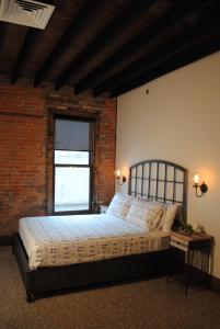 a bedroom with a bed and a window at The 1857 in Paducah