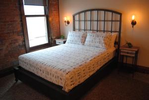a bedroom with a large bed and two windows at The 1857 in Paducah