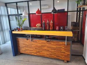 a yellow and blue counter in an office at Hotel Montha in Chiang Mai