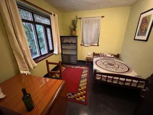 a living room with a bed and a window at Room in Traditional Nepali house in Kathmandu
