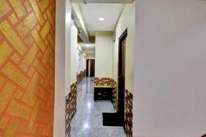 a hallway with stairs and a wooden door at Hotel O Parasol Inn Gangtok in Gangtok