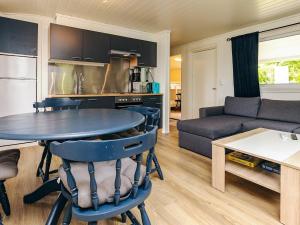a kitchen and living room with a table and a couch at 6 person holiday home in Løkken in Løkken +31 photos