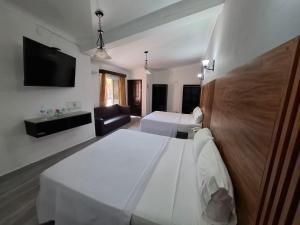 Postel nebo postele na pokoji v ubytování Hotel Aquiles