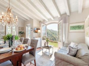 a dining room with a table and a chandelier at Tuscan Farmhouse with Infinity Pool Retreat in Matraia