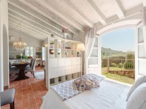 a bedroom with a bed and a dining room at Tuscan Farmhouse with Infinity Pool Retreat in Matraia +59 photos