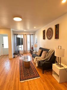 a living room with a couch and a table at Charming & Cozy Family Home Near Plaza, Movie hall in Cornwall