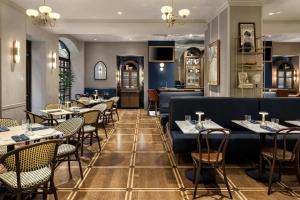 a restaurant with tables and chairs and a bar at The Talbott, Autograph Collection in Chicago