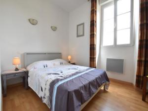 a white bedroom with a bed and a window at Modern holiday home in Crux-La-Ville with terrace in Crux-la-Ville