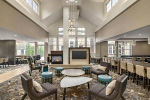 a lobby with a pool table and chairs and a television at Residence Inn by Marriott Albany Washington Avenue in Albany