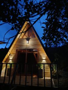 a cabin with a lit up door at night at El escondite in San Vicente