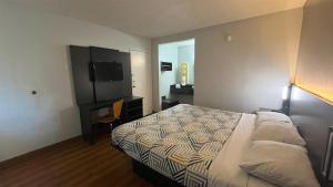 a hotel room with a bed and a television at Motel 6 Modesto, CA in Modesto