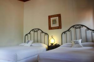Ліжко або ліжка в номері Hotel Plaza Yat Balam