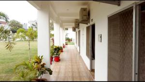 an empty corridor of a building with plants at The Vasudha Estate in Lucknow