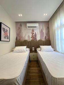 two beds sitting next to each other in a room at Porto Matrouh in Marsa Matruh