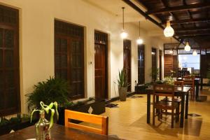 a dining room with a table and chairs at Oasis Bay - Arugam Bay in Arugam Bay