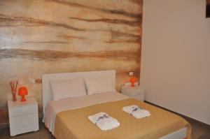 - une chambre avec un lit et 2 serviettes dans l'établissement Alicata B&b La Dimora Del Vento, à Licata