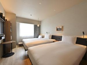 GRIDS PREMIUM HOTEL OTARU客房内的一张或多张床位