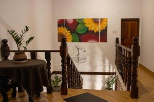 a staircase with a table and a painting on the wall at Oasis Bay - Arugam Bay in Arugam Bay