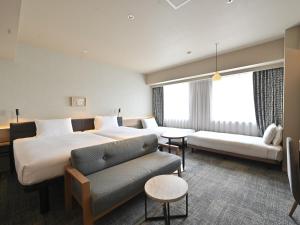 GRIDS PREMIUM HOTEL OTARU客房内的一张或多张床位