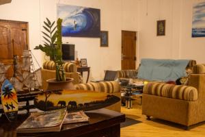 a living room with couches and a table at Oasis Bay - Arugam Bay in Arugam Bay