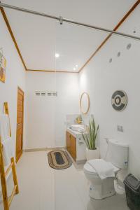 a bathroom with a toilet and a sink at Villa Lemone Braban by Bali Villa Solutions in Seminyak +28 photos