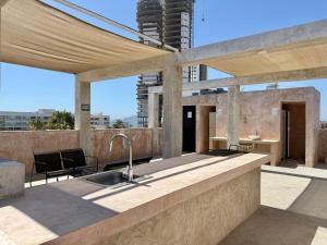 an outdoor kitchen with a sink on a roof at Loft a few blocks from the beach in Mazatlán