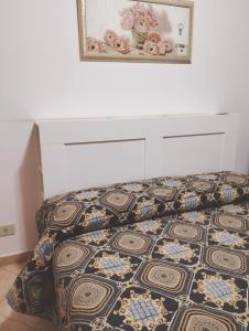 sypialnia z łóżkiem i zdjęciem na ścianie w obiekcie La Perla B & B w Ciampino