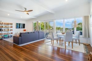 a living room with a couch and a table and chairs at Yaringa -13 Seaview Street SWR in South West Rocks