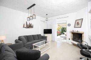 a living room with a couch and a fireplace at House Soko - 30m to Beach, near Mako and Elephant beach bar in Pefkohori