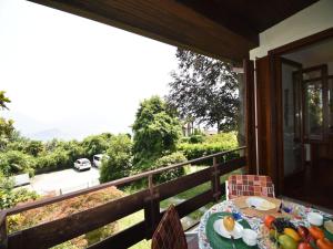 a table with a plate of fruit on a balcony at Villa in Valdora with Lake Maggiore Views in Ghiffa +25 photos