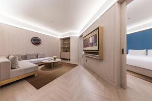 Voodi või voodid majutusasutuse Tianjin Baodi Economic Development Zone Orange Crystal Hotel toas