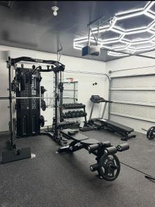 a fitness room with a gym with a treadmill and weights at Green Meadow Homestay in San Antonio