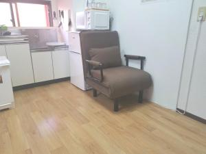 a chair sitting in a kitchen with a microwave at HouseKL in Tokyo +6 photos