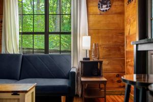 a living room with a blue couch and a window at MTN Views, Hot Tub, WiFi, Sleeps 3 in Sevierville +34 photos
