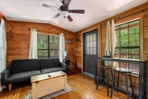 a living room with a couch and a ceiling fan at MTN Views, Hot Tub, WiFi, Sleeps 3 in Sevierville