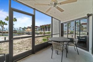 a patio with a table and chairs and a view of the beach at Pointe Santo C1 in Sanibel