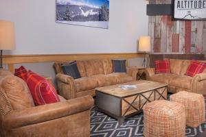 a living room filled with furniture and a tv at Evergreen Lodge at Vail in Vail