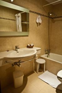 a bathroom with a sink and a tub and a toilet at Hotel Alameda in Zarautz +31 photos