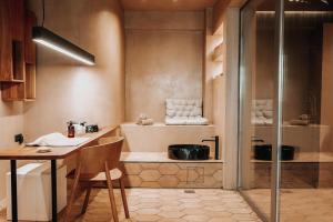 a small kitchen with a table and a glass door at Sagredo Boutique Hotel & Spa in Ágios Fokás