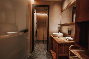 a bathroom with two sinks and two mirrors at Sagredo Boutique Hotel & Spa in Ágios Fokás