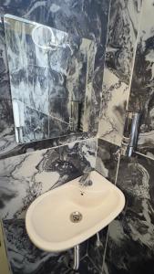 a bathroom with a sink and a mirror at Hotel Prisha Recidency in Wardha +46 photos