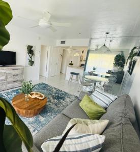 a living room with a couch and a table at Designer's 1 BR 1BA Condo 1 Block to Aventura Mall in Aventura