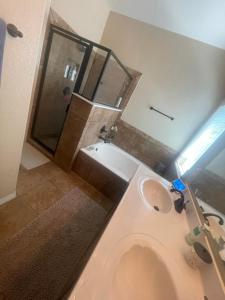 a bathroom with a toilet and a sink and a shower at Casa Bonita in Horizon City